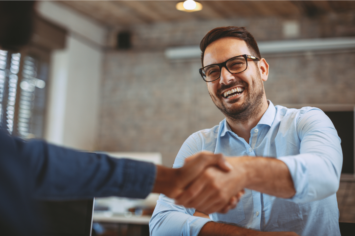 Close up of two guys handshaking in the office